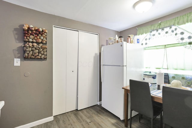 kitchen with wood-type flooring and white fridge