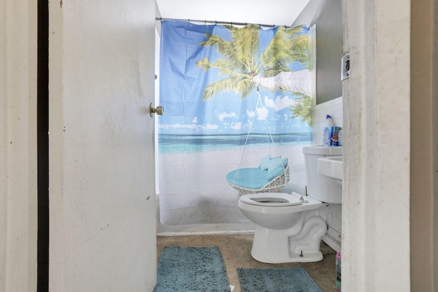 bathroom with toilet and tile patterned flooring