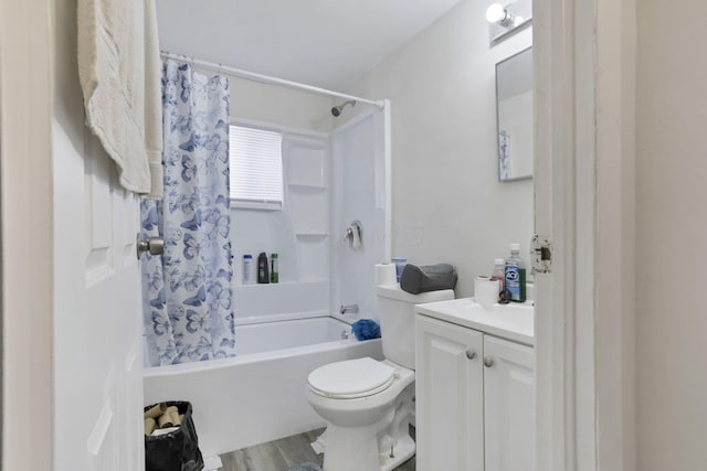 full bathroom with shower / bath combo with shower curtain, hardwood / wood-style flooring, vanity, and toilet