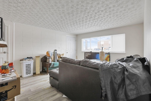 living room featuring a textured ceiling and light hardwood / wood-style floors