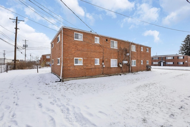 view of snow covered rear of property