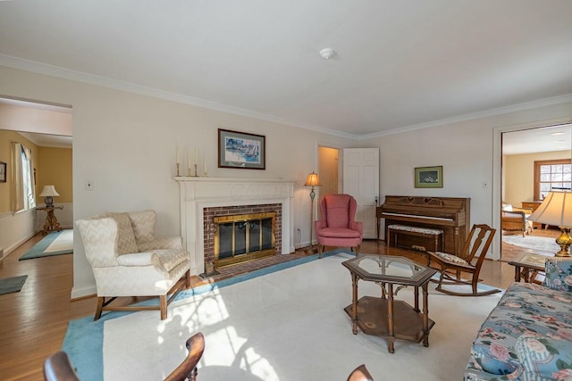 living room with ornamental molding, light wood-type flooring, and a fireplace