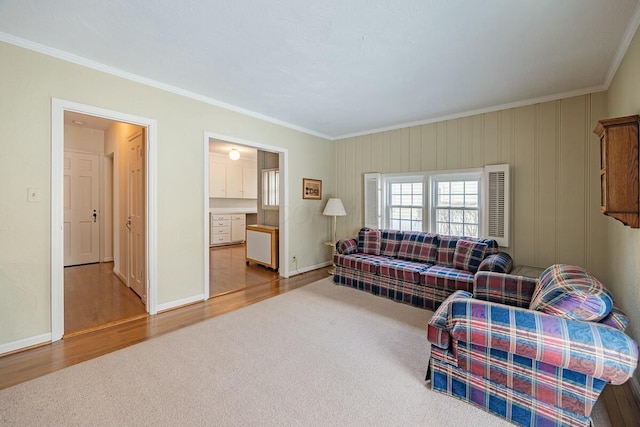 carpeted living room featuring ornamental molding