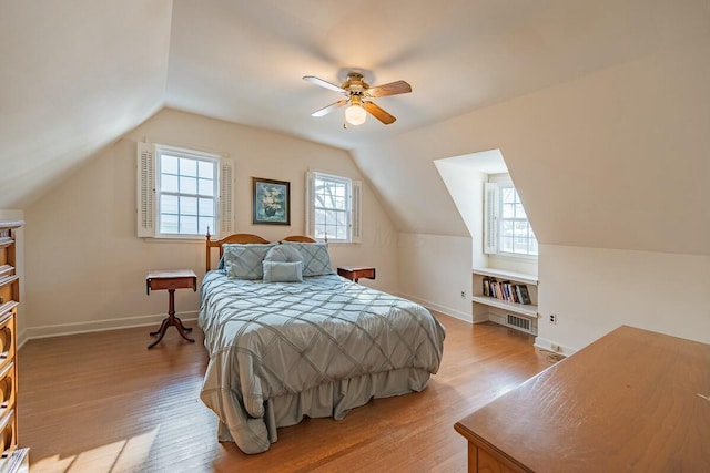 bedroom with multiple windows, ceiling fan, and light wood-type flooring