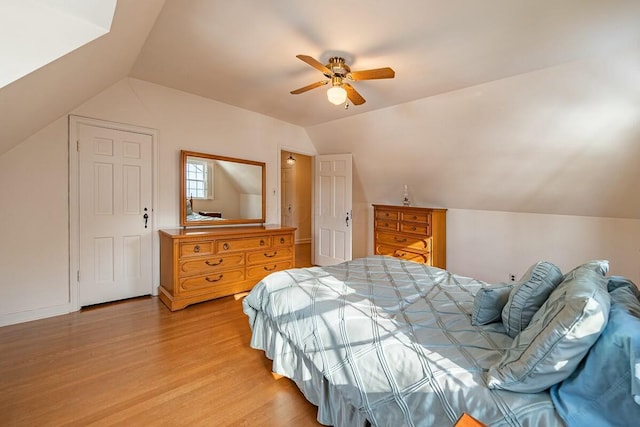 bedroom with vaulted ceiling, ceiling fan, and light hardwood / wood-style flooring