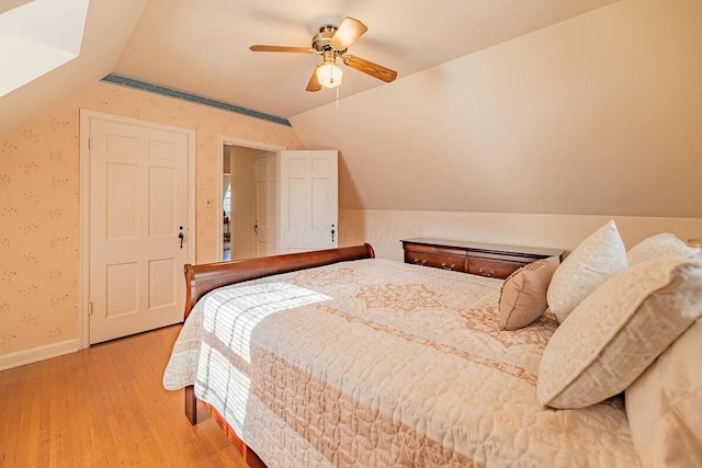 bedroom featuring vaulted ceiling, ceiling fan, and hardwood / wood-style flooring