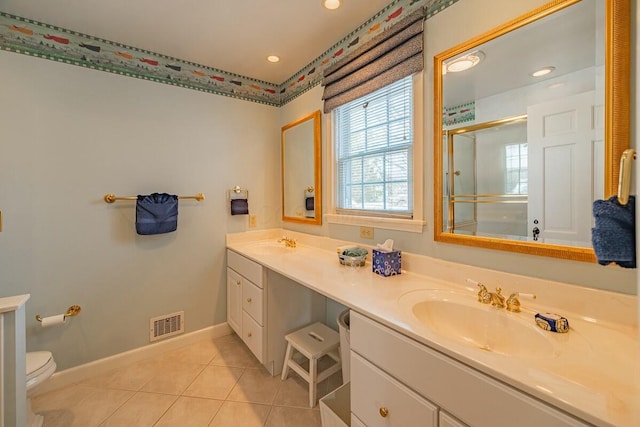 bathroom featuring toilet, a shower with door, tile patterned flooring, and vanity