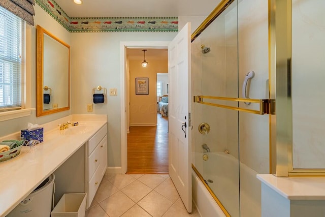 bathroom featuring vanity, shower / bath combination with glass door, and tile patterned floors