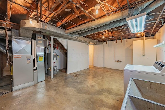 basement featuring washing machine and dryer and gas water heater