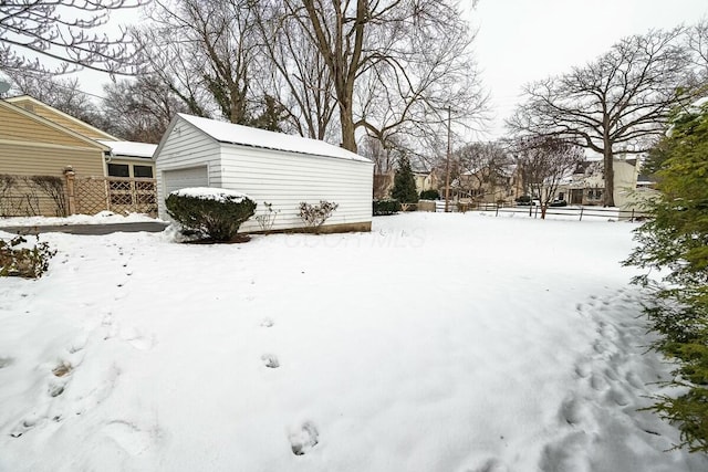 yard covered in snow with a garage