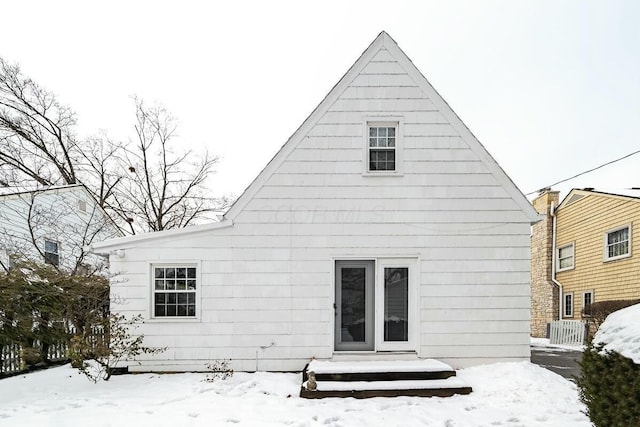 view of snow covered back of property