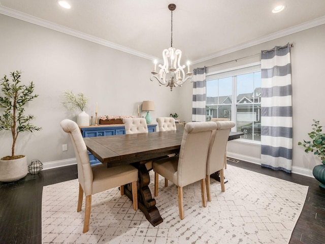 dining area with crown molding, a chandelier, and hardwood / wood-style flooring