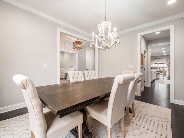 dining space with a chandelier, wood-type flooring, and ornamental molding