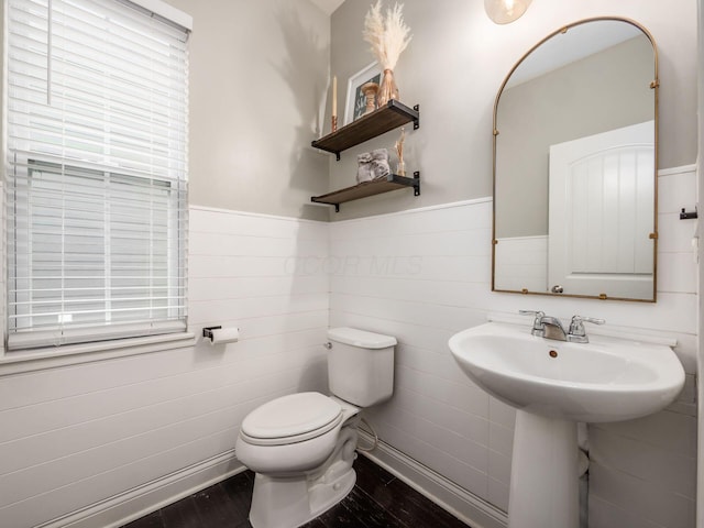 bathroom featuring hardwood / wood-style flooring and toilet