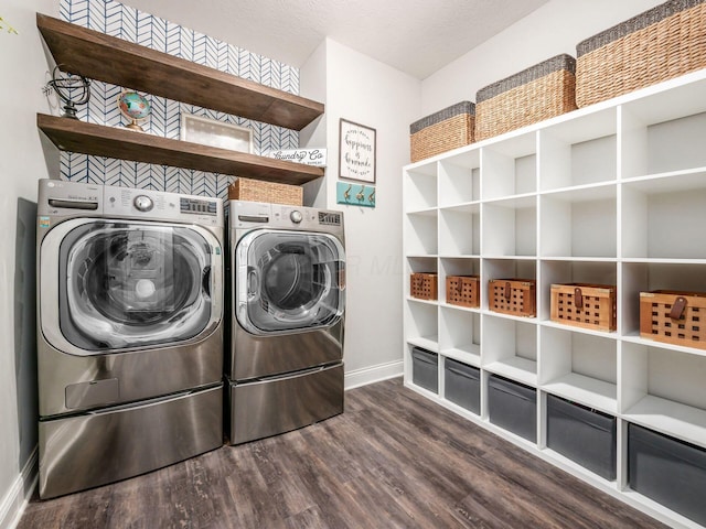 laundry area featuring washer and dryer and dark hardwood / wood-style flooring