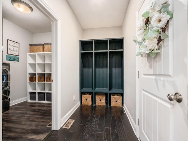 mudroom with dark hardwood / wood-style floors and washer / dryer