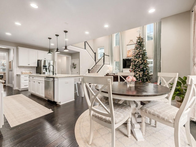 dining space featuring a wealth of natural light and dark wood-type flooring