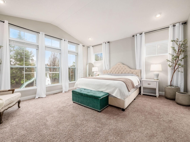 carpeted bedroom with lofted ceiling