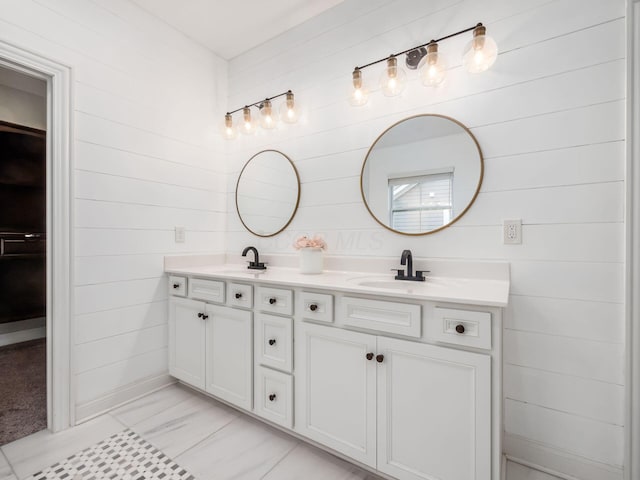 bathroom featuring tile patterned floors, vanity, and wood walls