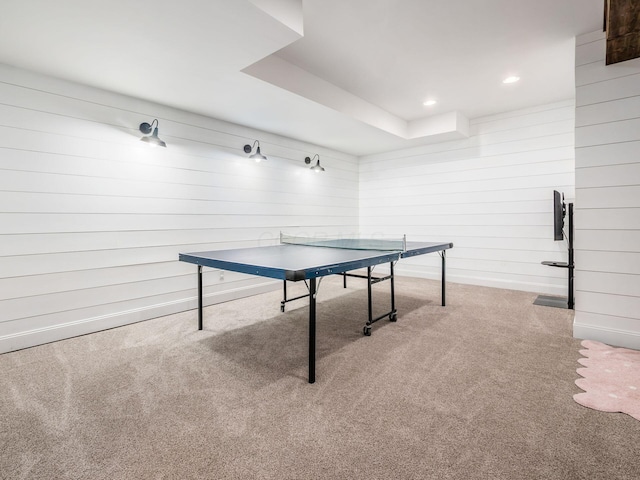 playroom featuring carpet floors and wooden walls