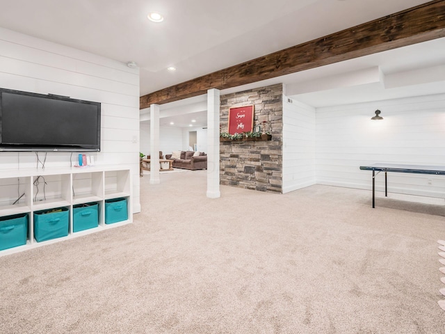 game room featuring carpet, wood walls, and beamed ceiling