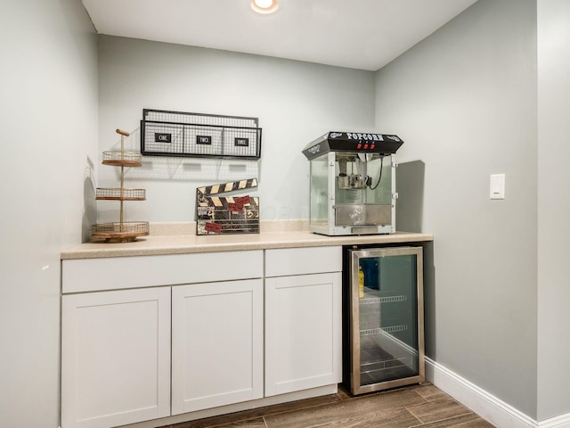 bar featuring wine cooler and white cabinets