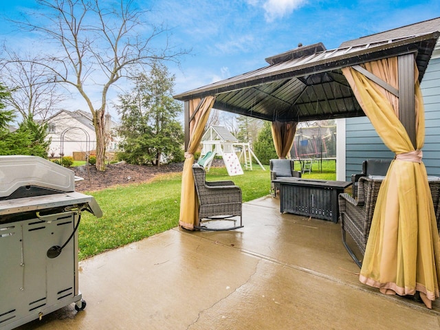 view of patio with a gazebo, a trampoline, and a playground