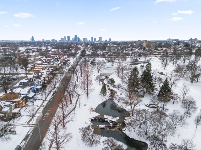 snowy aerial view featuring a water view