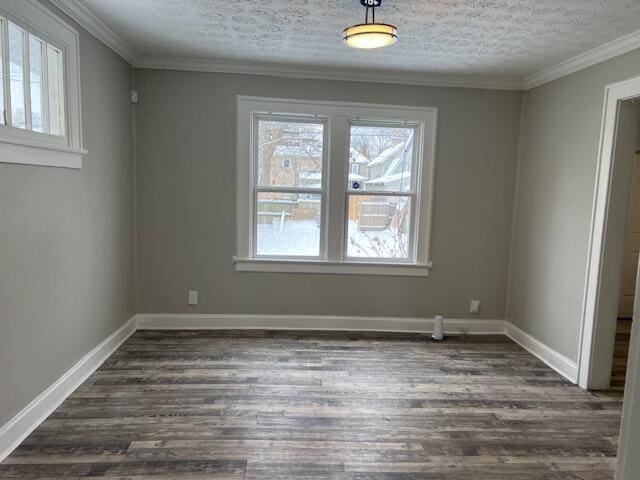 unfurnished dining area featuring crown molding, a textured ceiling, and dark wood-type flooring