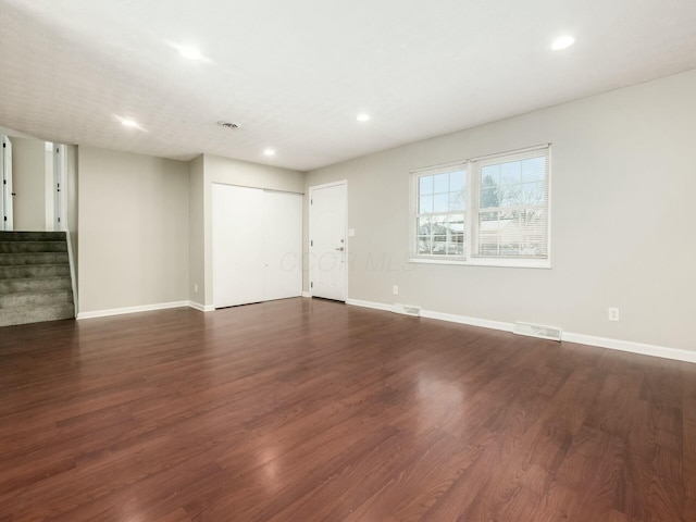 empty room with dark hardwood / wood-style floors