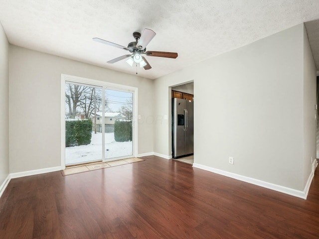 unfurnished room with a textured ceiling, ceiling fan, and hardwood / wood-style flooring