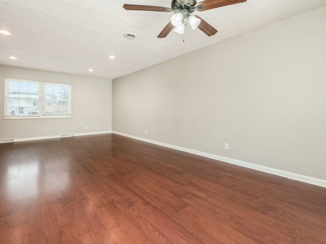 empty room with a textured ceiling, ceiling fan, and wood-type flooring