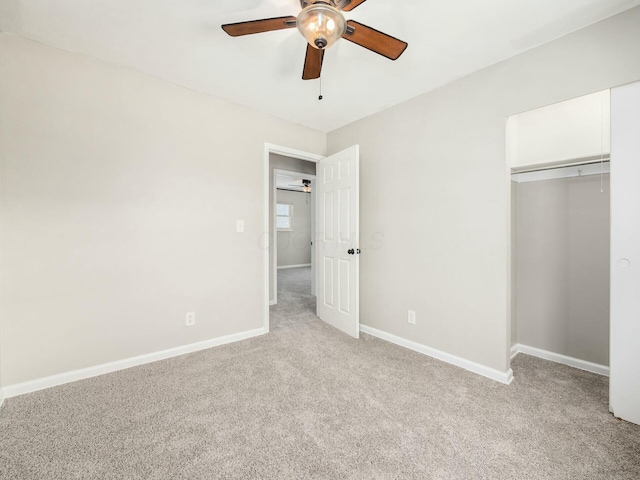 unfurnished bedroom featuring a closet, ceiling fan, and light colored carpet