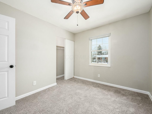 unfurnished bedroom featuring a closet, carpet floors, and ceiling fan