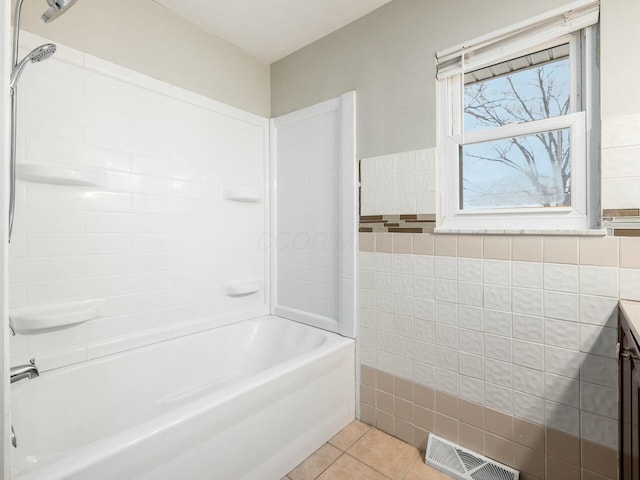 bathroom featuring tile walls, tub / shower combination, tile patterned floors, and vanity