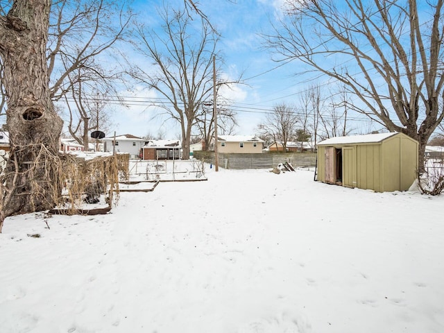 snowy yard with a shed