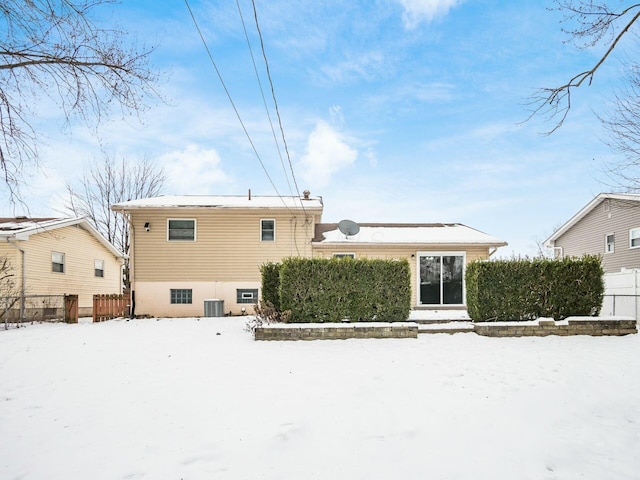 snow covered property with cooling unit