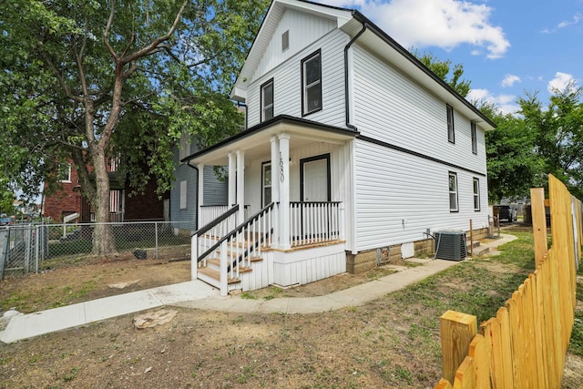 view of front of house with covered porch and central air condition unit