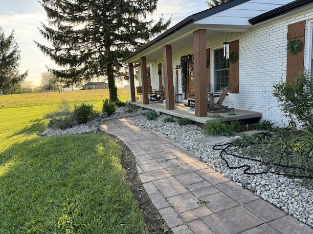 yard at dusk featuring a porch