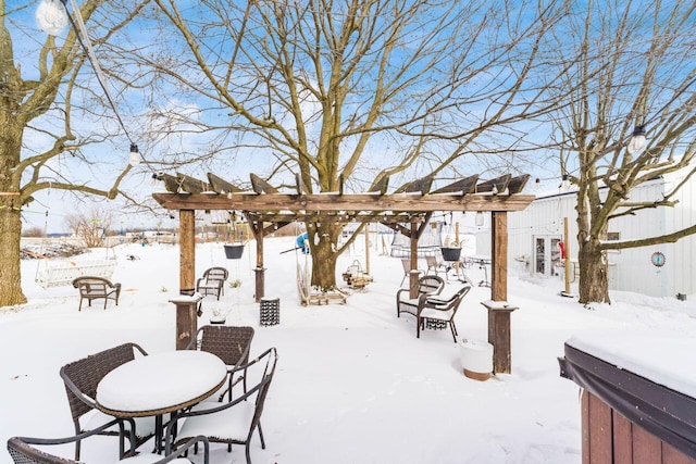 snow covered patio with a pergola