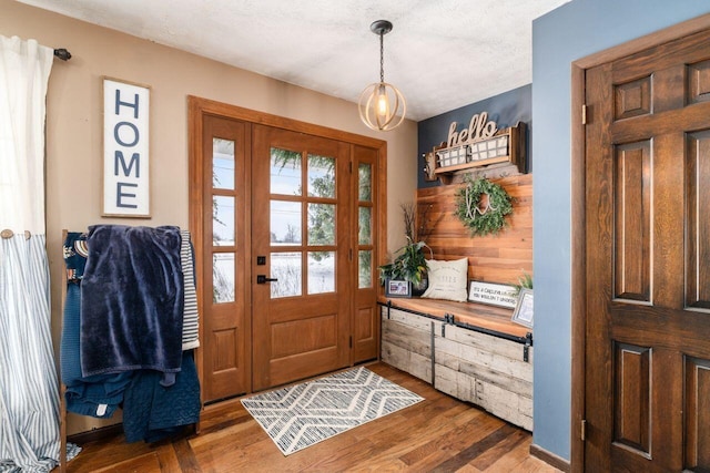 foyer featuring dark wood-type flooring and a textured ceiling