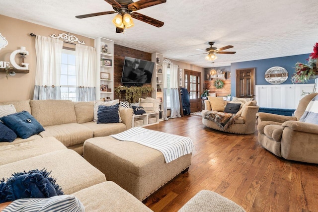 living room featuring a wealth of natural light, a textured ceiling, and hardwood / wood-style flooring