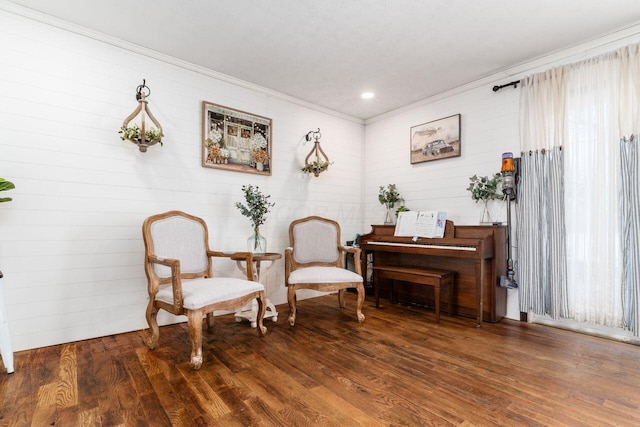 living area with a wealth of natural light, crown molding, and dark wood-type flooring