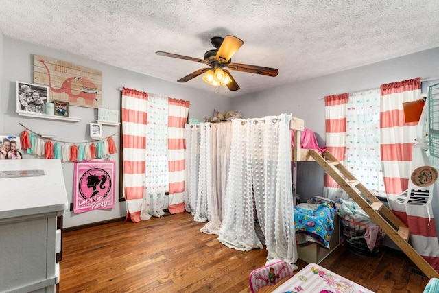 bedroom featuring hardwood / wood-style flooring, ceiling fan, and a textured ceiling