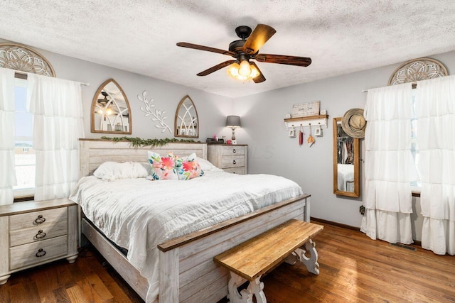 bedroom featuring hardwood / wood-style flooring, ceiling fan, and a textured ceiling