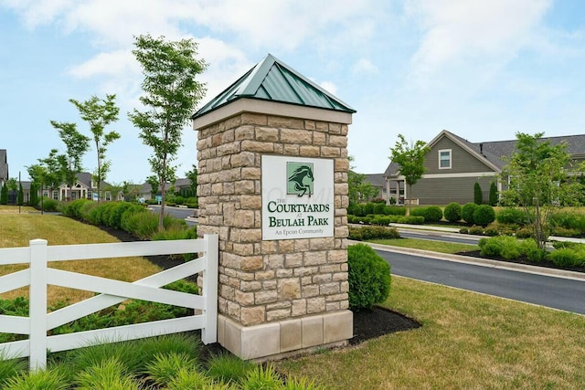 community / neighborhood sign with a lawn