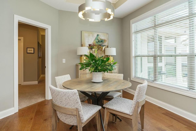 dining area featuring hardwood / wood-style floors and a notable chandelier