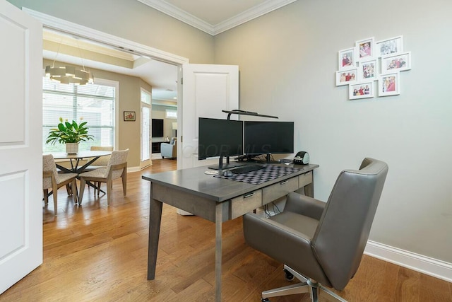 office space featuring crown molding, light hardwood / wood-style floors, and an inviting chandelier