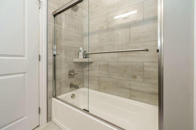 bathroom with combined bath / shower with glass door and tile patterned floors