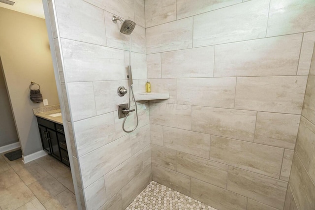 bathroom featuring vanity and a tile shower